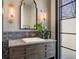 Stylish powder room featuring a modern vanity, unique lighting, and elegant mirror at 1291 S Gaylord St, Denver, CO 80210