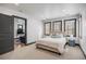 Cozy bedroom featuring three bright windows and an open doorway to a living room space at 1291 S Gaylord St, Denver, CO 80210