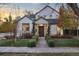 Charming two-story home with a walkway, manicured lawn, and tasteful landscaping at 1291 S Gaylord St, Denver, CO 80210
