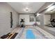 Well-lit home gym featuring wood-look floors and exercise equipment at 1291 S Gaylord St, Denver, CO 80210