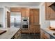 Kitchen features stainless steel appliances, custom cabinetry, and stone countertops at 1291 S Gaylord St, Denver, CO 80210