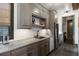Wet bar features custom cabinets, stone countertop, and stainless steel beverage refrigerator at 1291 S Gaylord St, Denver, CO 80210