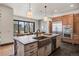 Bright, modern kitchen with stainless steel appliances, farmhouse sink and center island with pendant lighting at 1291 S Gaylord St, Denver, CO 80210