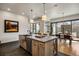 Spacious kitchen with center island, modern lighting, and sliding doors to outdoor dining at 1291 S Gaylord St, Denver, CO 80210