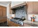 Gourmet kitchen boasts stainless steel range, custom hood, and backsplash at 1291 S Gaylord St, Denver, CO 80210