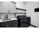 Well-equipped laundry room with modern washer and dryer and ample storage at 1291 S Gaylord St, Denver, CO 80210