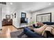 Inviting living room featuring comfortable seating, a large TV, and bookshelf in the background at 1291 S Gaylord St, Denver, CO 80210