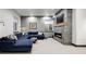 Basement living room with tv and cozy blue sectional couch, perfect for entertainment at 1291 S Gaylord St, Denver, CO 80210