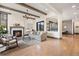 Open concept living room with fireplace and hardwood floors at 1291 S Gaylord St, Denver, CO 80210