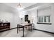 Bright home office features a modern desk, shelving, and light-colored walls at 1291 S Gaylord St, Denver, CO 80210