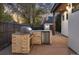An outdoor kitchen boasts a stone grill, refrigerator, and ample counter space at 1291 S Gaylord St, Denver, CO 80210