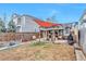Large backyard featuring a cozy patio with shade and plenty of room for entertaining at 2033 S Ogden St, Denver, CO 80210