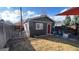 Backyard featuring a garage and a patio with a fire pit and a well maintained lawn at 2033 S Ogden St, Denver, CO 80210