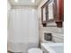 Close up of a bathroom with pedestal sink, toilet, shower and medicine cabinet at 2033 S Ogden St, Denver, CO 80210