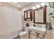 Bathroom featuring pedestal sink, shower with curtain, and medicine cabinet at 2033 S Ogden St, Denver, CO 80210