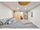 Unique bedroom featuring a sliding barn door, a painted ceiling, and gray bedding at 2033 S Ogden St, Denver, CO 80210