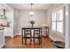 Bright dining area with hardwood floors and an open view into a white kitchen at 2033 S Ogden St, Denver, CO 80210