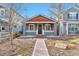 Charming gray single-story home with a red brick walkway and a welcoming front porch at 2033 S Ogden St, Denver, CO 80210