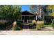 Charming single-story home with well-manicured landscaping and a welcoming brick pathway at 2033 S Ogden St, Denver, CO 80210