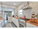 Well-lit kitchen featuring butcher block counters, white subway tile backsplash and stainless appliances at 2033 S Ogden St, Denver, CO 80210