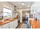 Bright kitchen featuring butcher block counters, white subway tile, and stainless steel appliances at 2033 S Ogden St, Denver, CO 80210