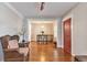 Spacious living room with hardwood floors flowing into the dining area, featuring a red entry door at 2033 S Ogden St, Denver, CO 80210