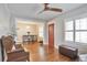 Bright living room featuring hardwood floors, a red front door, and large windows with shutters at 2033 S Ogden St, Denver, CO 80210