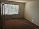 Empty bedroom with carpet, window with blinds, and natural light at 9913 E Carolina Cir # 203, Denver, CO 80247