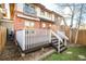 Backyard with a wooden deck and steps, showing the multi-story home and partial fence at 449 N Pearl St, Denver, CO 80203