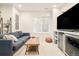 Finished basement including lounge seating, TV and beverage fridge at 449 N Pearl St, Denver, CO 80203