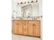 Bathroom vanity with granite countertop, decorative mirror, and wood cabinets at 449 N Pearl St, Denver, CO 80203