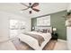 Bright bedroom with ceiling fan, ensuite deck access, and olive accent wall at 449 N Pearl St, Denver, CO 80203