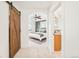 Inviting bedroom showcasing an en-suite bathroom and a barn door that enhances the home's character at 449 N Pearl St, Denver, CO 80203