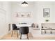 Bright breakfast nook with a charming built-in bench, complemented by desert-themed wall art and modern pendant lighting at 449 N Pearl St, Denver, CO 80203