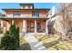 Charming brick duplex with a well-maintained front yard and covered porch at 449 N Pearl St, Denver, CO 80203