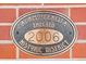 Alamo Placita Historic District plaque on the brick exterior at 449 N Pearl St, Denver, CO 80203
