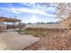 Backyard view with wooden pergola in the winter with leaves on the ground at 3869 S Himalaya Way, Aurora, CO 80013