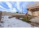 Backyard view with wooden pergola in the winter with snow on the ground at 3869 S Himalaya Way, Aurora, CO 80013