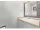 Cozy bathroom featuring a stylish sink vanity with a decorative mirror and neutral countertop at 3869 S Himalaya Way, Aurora, CO 80013
