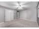 Spacious bedroom with plush carpeting, ceiling fan, and sliding closet doors for ample storage at 3869 S Himalaya Way, Aurora, CO 80013
