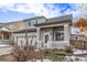 Charming two-story home featuring a gray stucco exterior, covered porch, and attached two-car garage at 3869 S Himalaya Way, Aurora, CO 80013