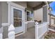 Close-up of the home's inviting front porch with white picket fence and decorative wreath at 3869 S Himalaya Way, Aurora, CO 80013