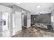View from the kitchen with stainless steel refrigerator and a seamless flow into the living room at 3869 S Himalaya Way, Aurora, CO 80013