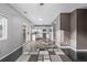 Open-concept living area flowing into a kitchen featuring a tile floor, stainless appliances, and white cabinetry at 3869 S Himalaya Way, Aurora, CO 80013