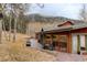 Scenic backyard featuring a wood deck with outdoor furniture and sliding glass doors to the house at 2720 S Spring Gulch Rd, Idaho Springs, CO 80452