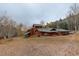 Expansive backyard view featuring wooded landscape and a well-maintained lawn with an outbuilding at 2720 S Spring Gulch Rd, Idaho Springs, CO 80452