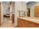 Bright bathroom featuring tile flooring, wooden vanity with a large mirror, and access to the bedroom at 2720 S Spring Gulch Rd, Idaho Springs, CO 80452