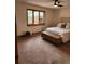 Bright bedroom featuring a large window with natural light and neutral decor at 2720 S Spring Gulch Rd, Idaho Springs, CO 80452