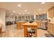 Spacious eat-in kitchen with natural wood cabinets, center island, and stainless steel appliances at 2720 S Spring Gulch Rd, Idaho Springs, CO 80452
