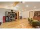 Spacious room featuring wood floors, a sofa, storage shelves, and a vaulted ceiling at 2720 S Spring Gulch Rd, Idaho Springs, CO 80452